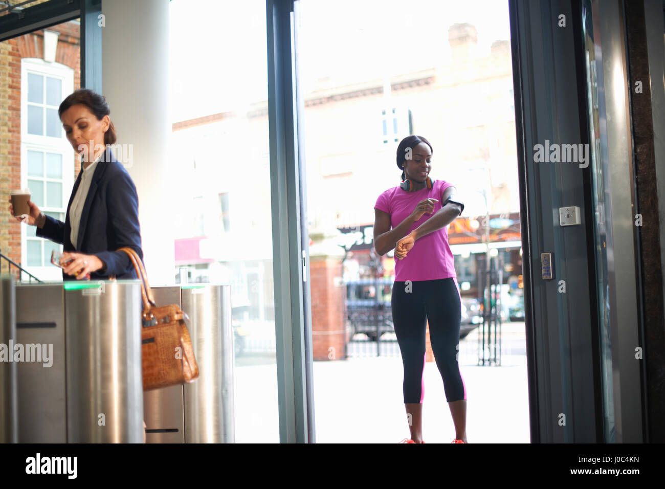Women arriving at entrance to work Stock Photo