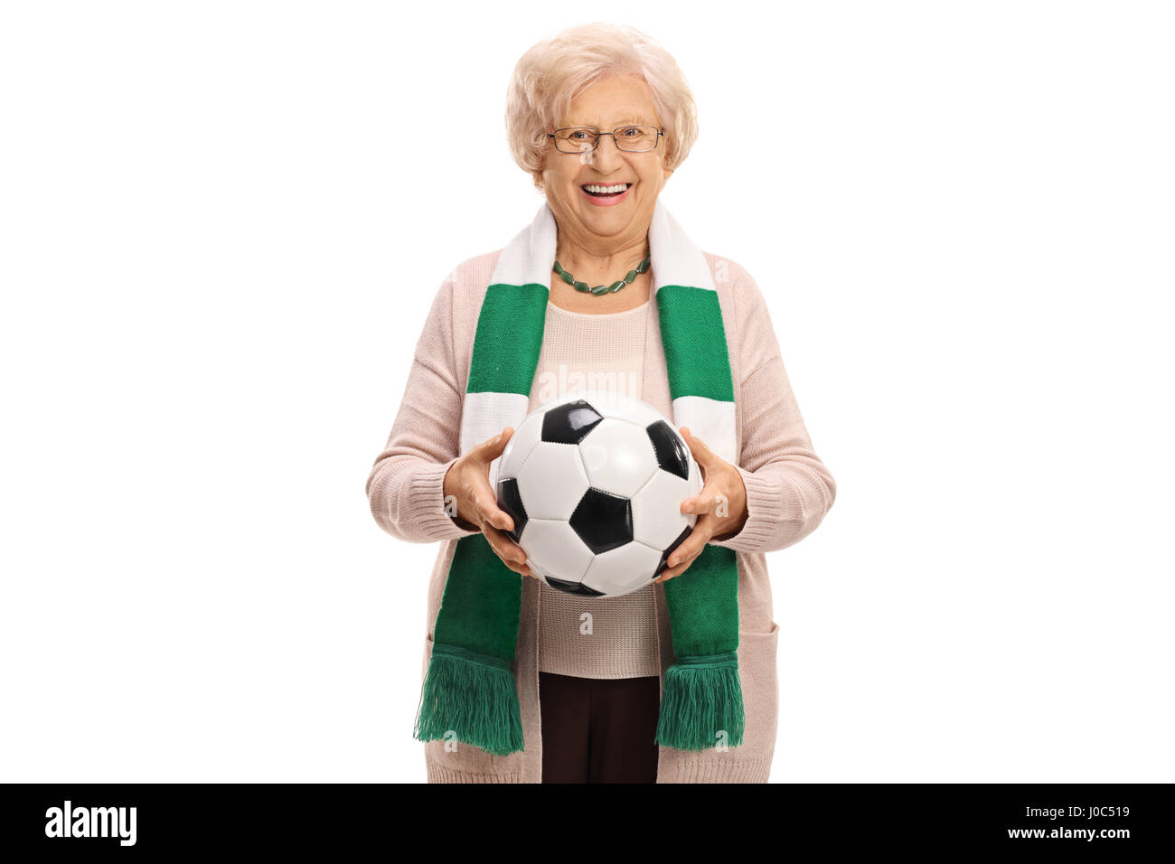 Delighted senior soccer fan with a scarf and a football isolated on white background Stock Photo