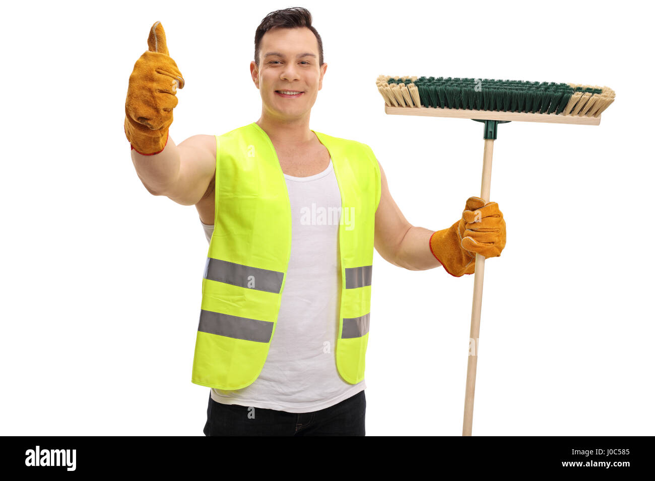 Happy waste collector holding a broom and making a thumb up sign isolated on white background Stock Photo