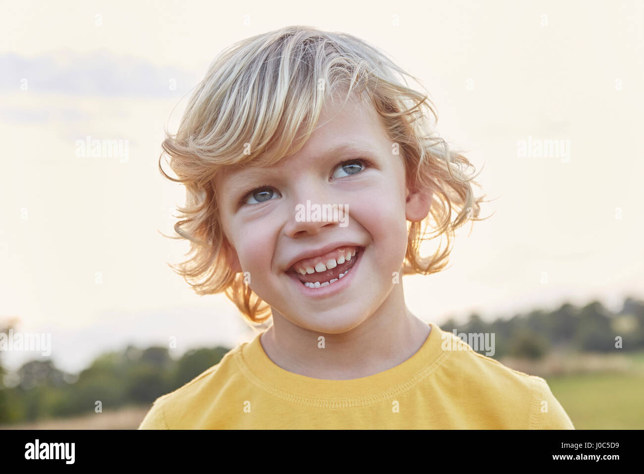 Portrait Of Blond Haired Blue Eyed Boy On Playing Field Stock