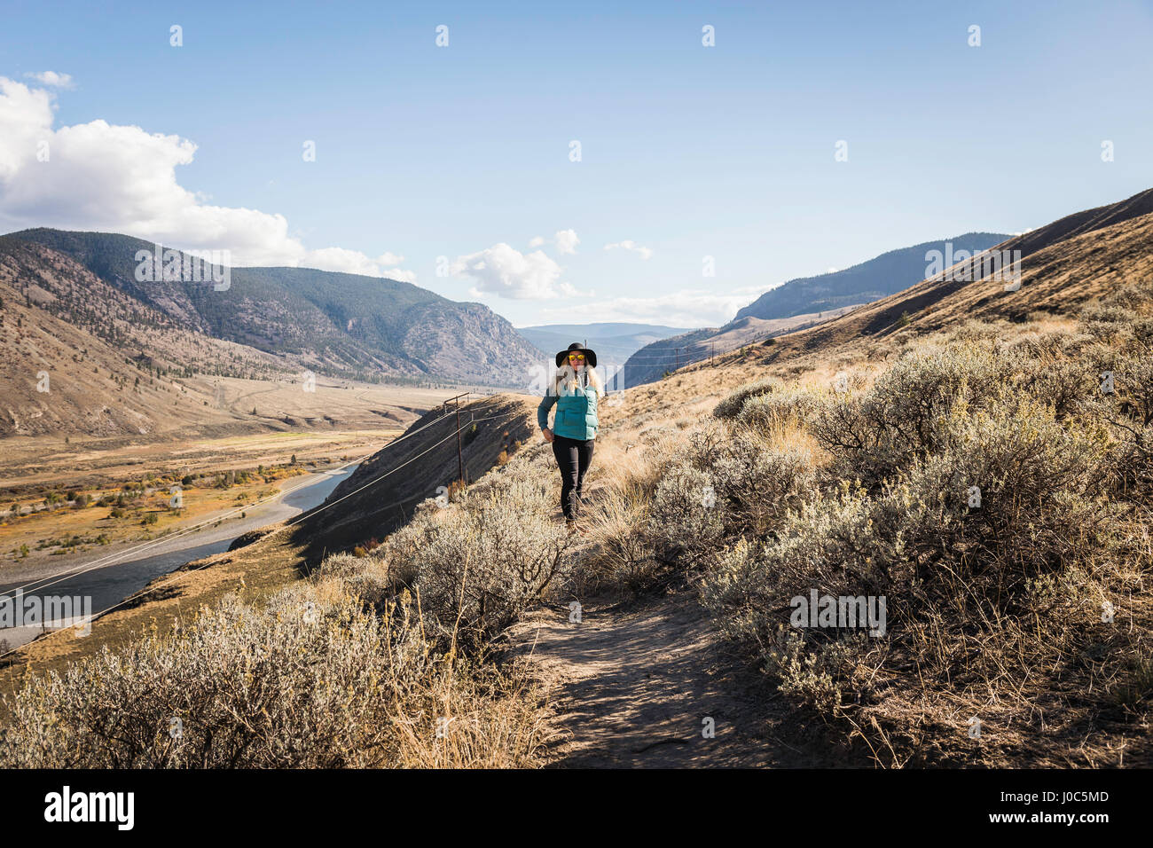 Woman hiking, Trans Canada Highway, near Kamloops, Boston Flats, British Columbia, Canada Stock Photo