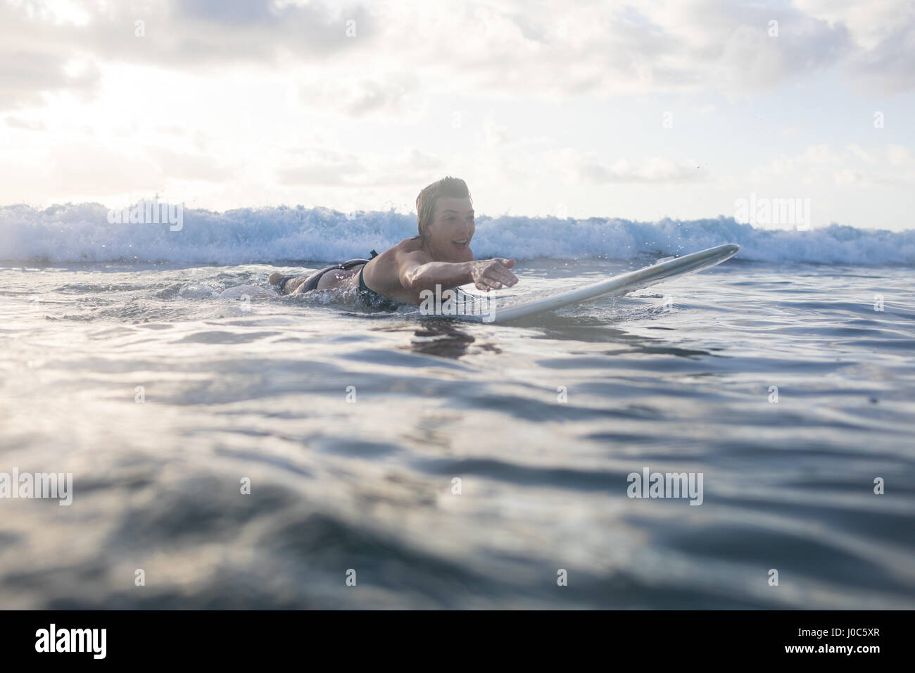 Woman paddling on surfboard in sea, Nosara, Guanacaste Province, Costa Rica Stock Photo