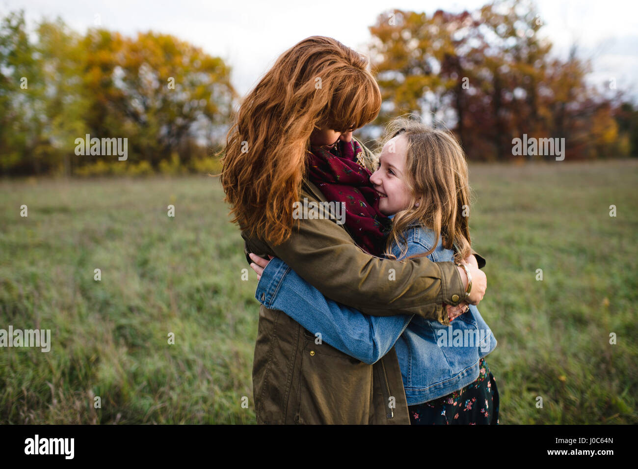 Mother and daughter hugging in meadow, Lakefield, Ontario, Canada Stock Photo