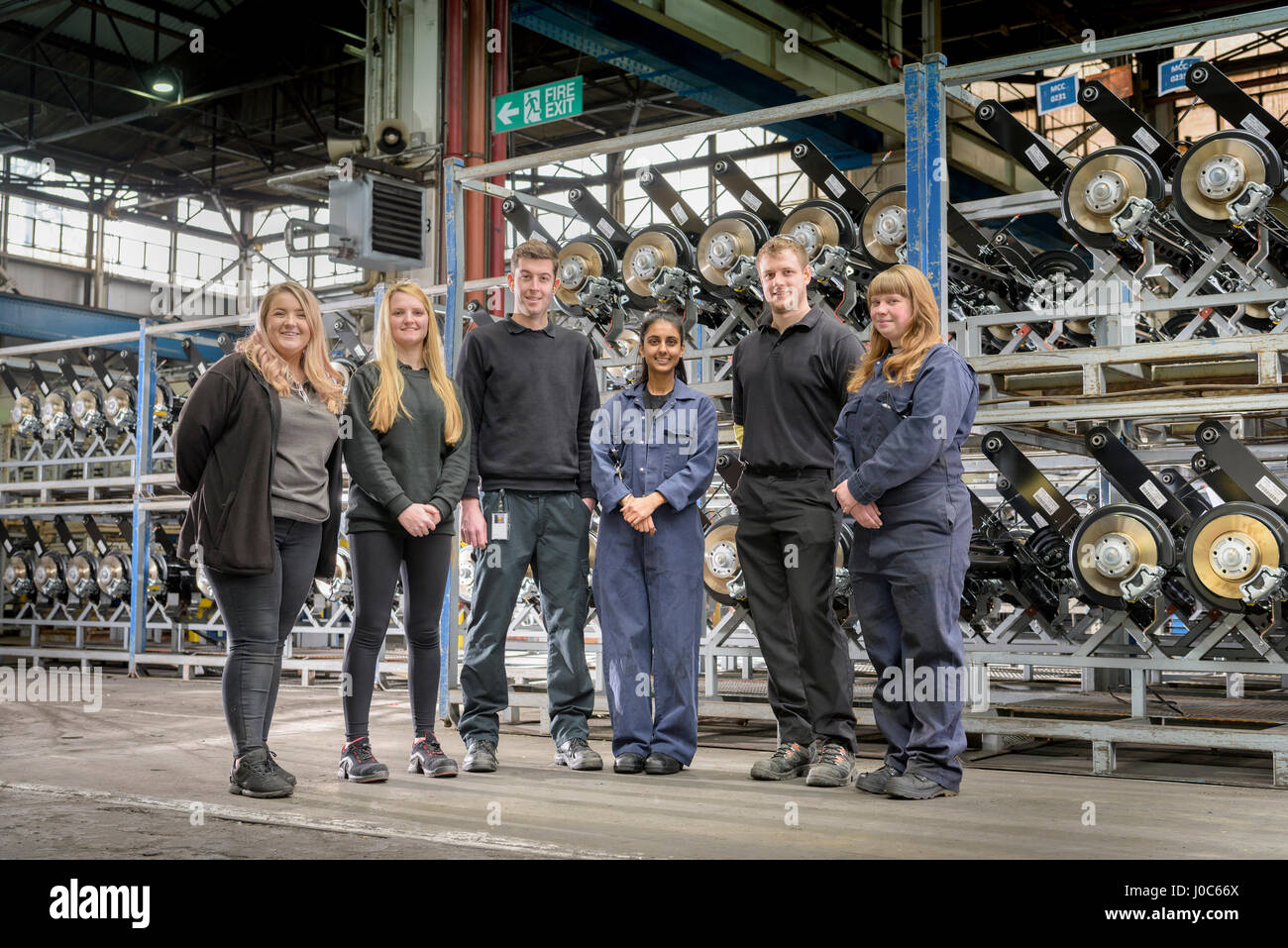 Group portrait of male and female apprentices in car factory Stock Photo