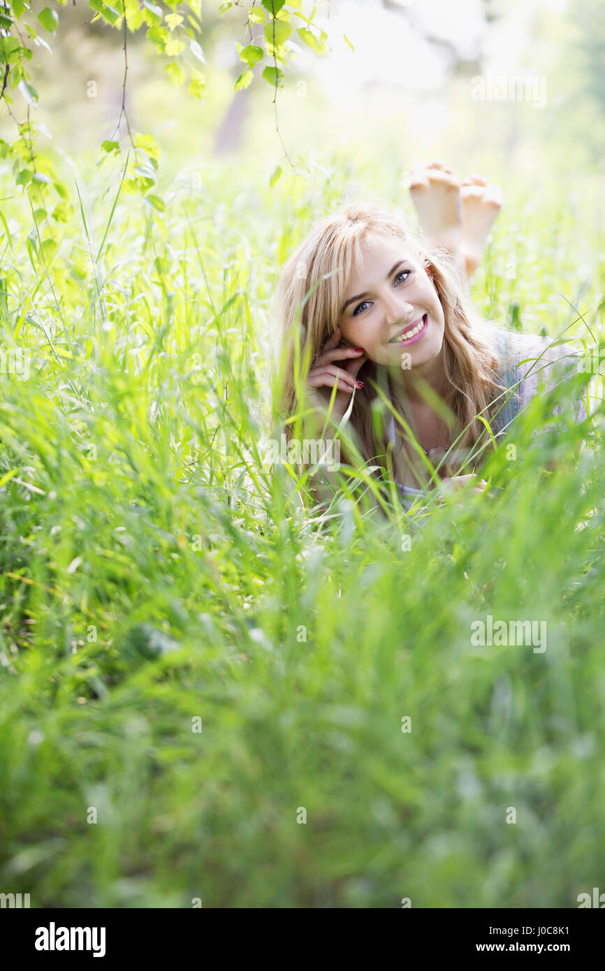 girl lying in the grass Stock Photo - Alamy