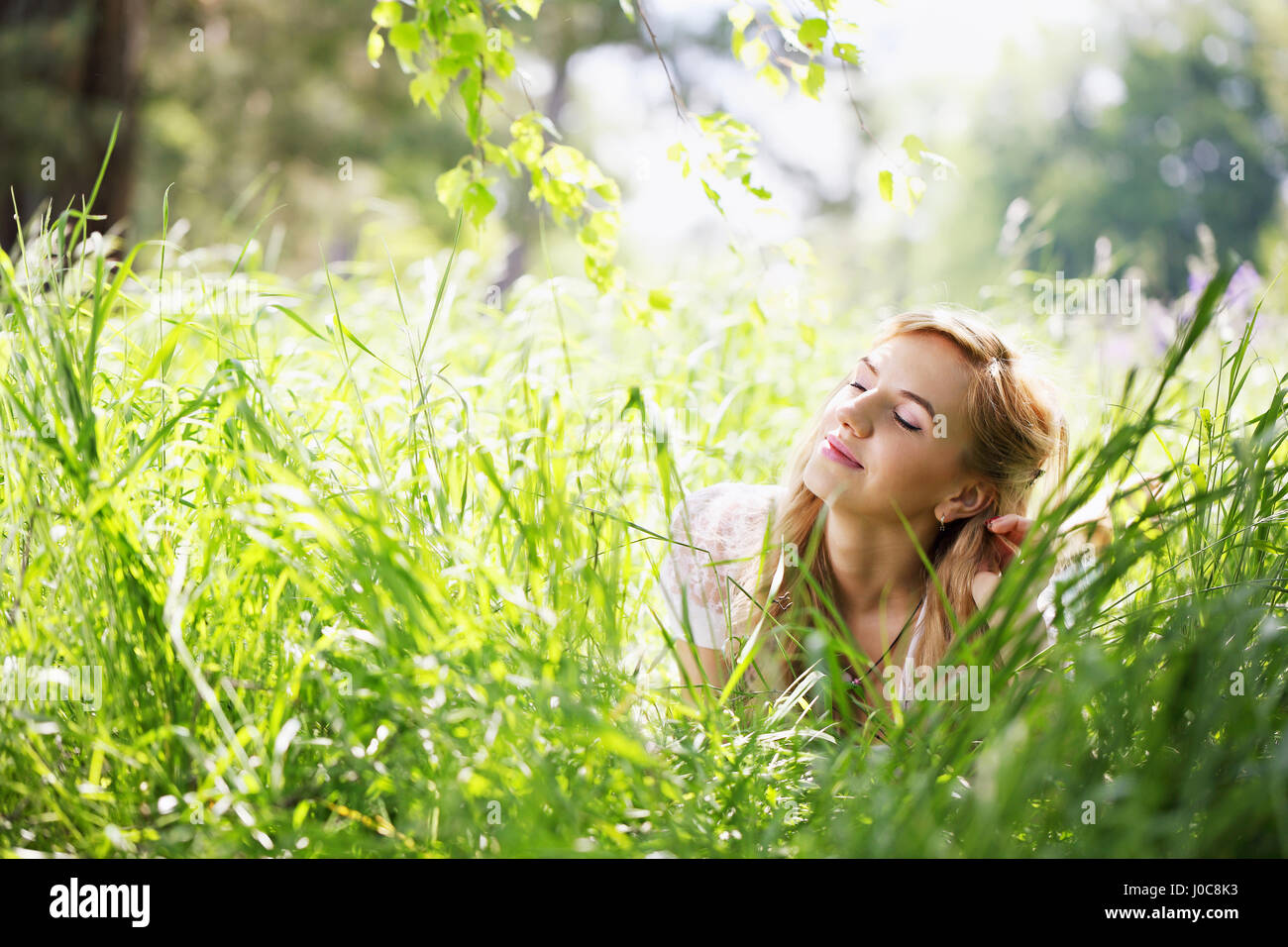 girl lying on the grass Stock Photo - Alamy