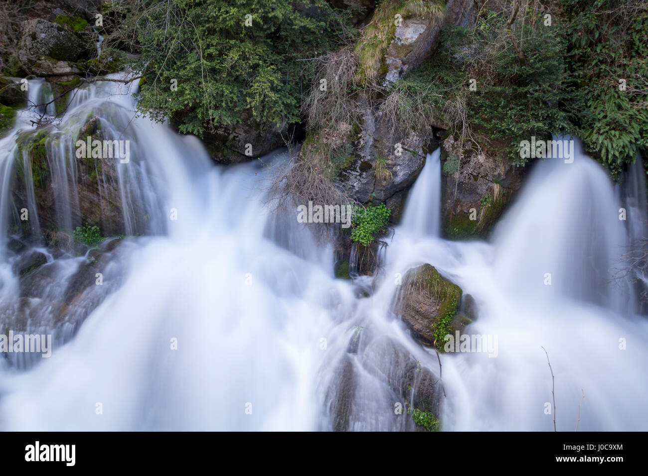 River source fountain, with water flowing from the rocks Stock Photo