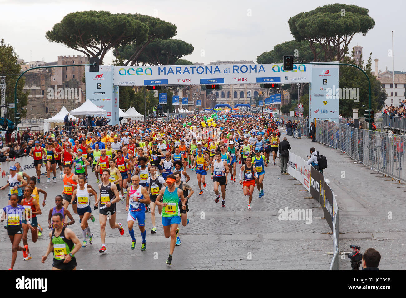 Rome, Italy - April 2, 2017: the departure of the athletes on Via dei Fori Imperiali, the Coliseum on background. Stock Photo