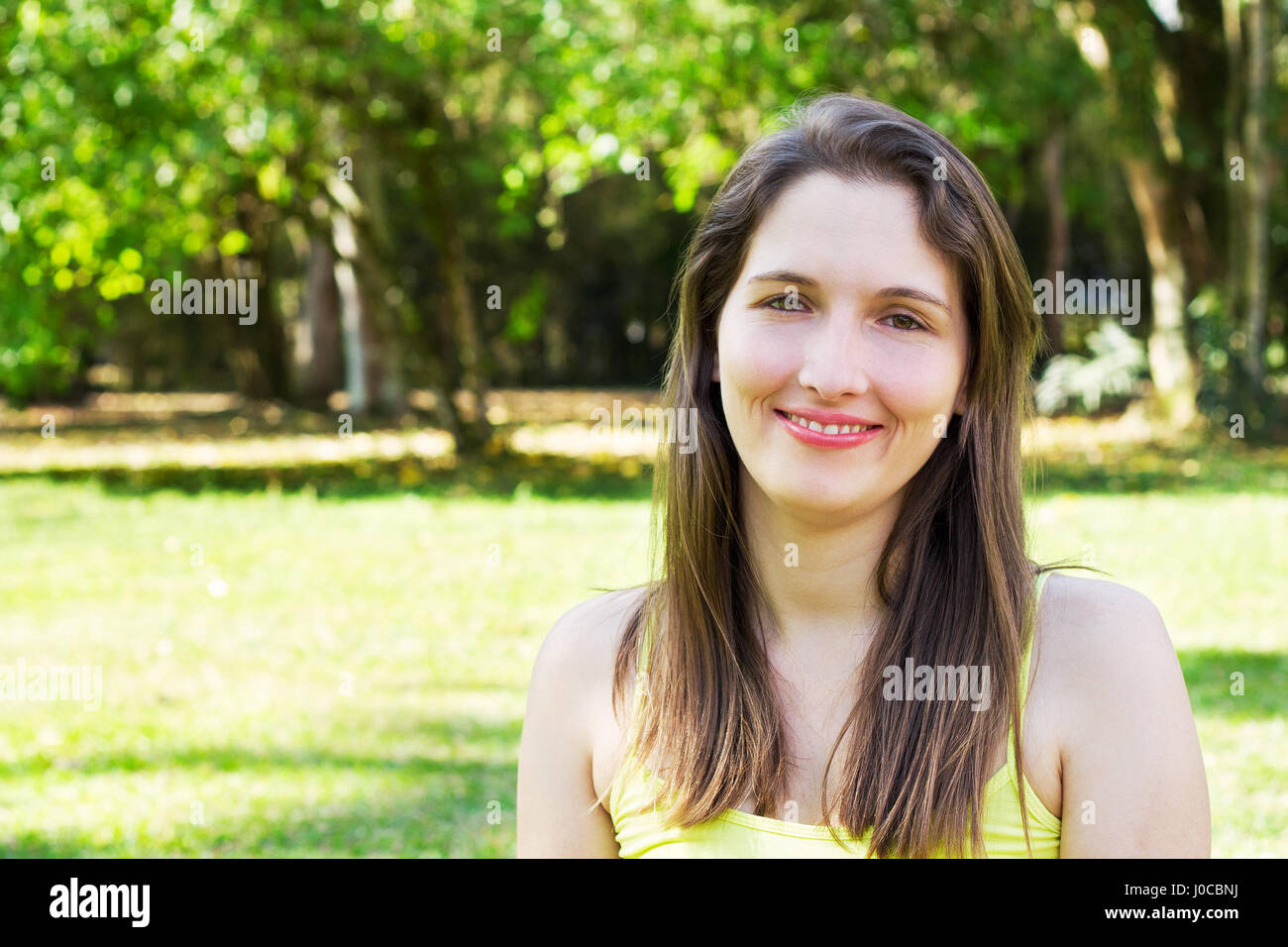 Woman in the park looking at camera Stock Photo