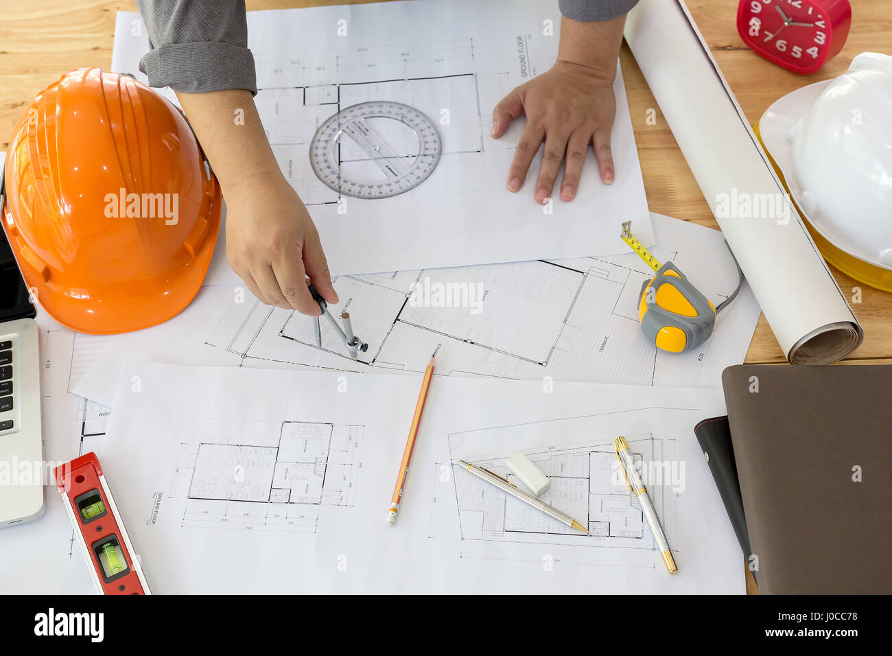 Architect working on blueprint. Architects workplace - architectural project, blueprints, ruler, calculator, laptop and divider compass. Construction  Stock Photo