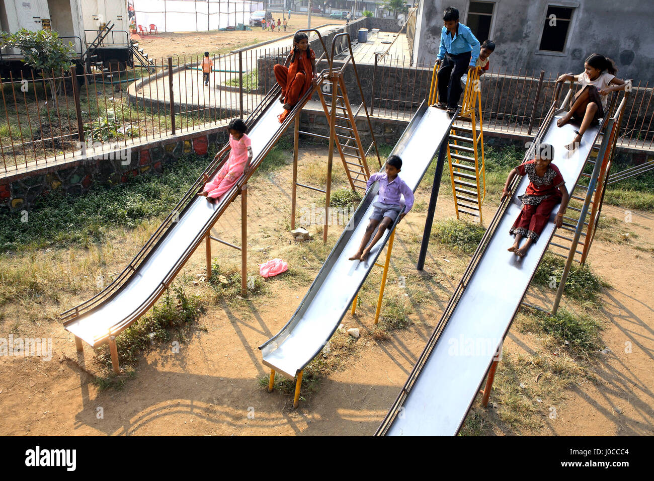 Children playing on slides, tilak nagar, mumbai, maharashtra, india, asia Stock Photo