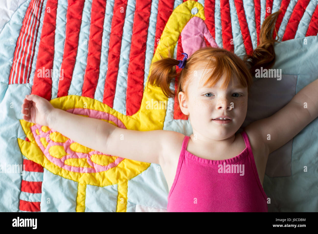 Portrait of young girl lying on blanket Stock Photo Alamy