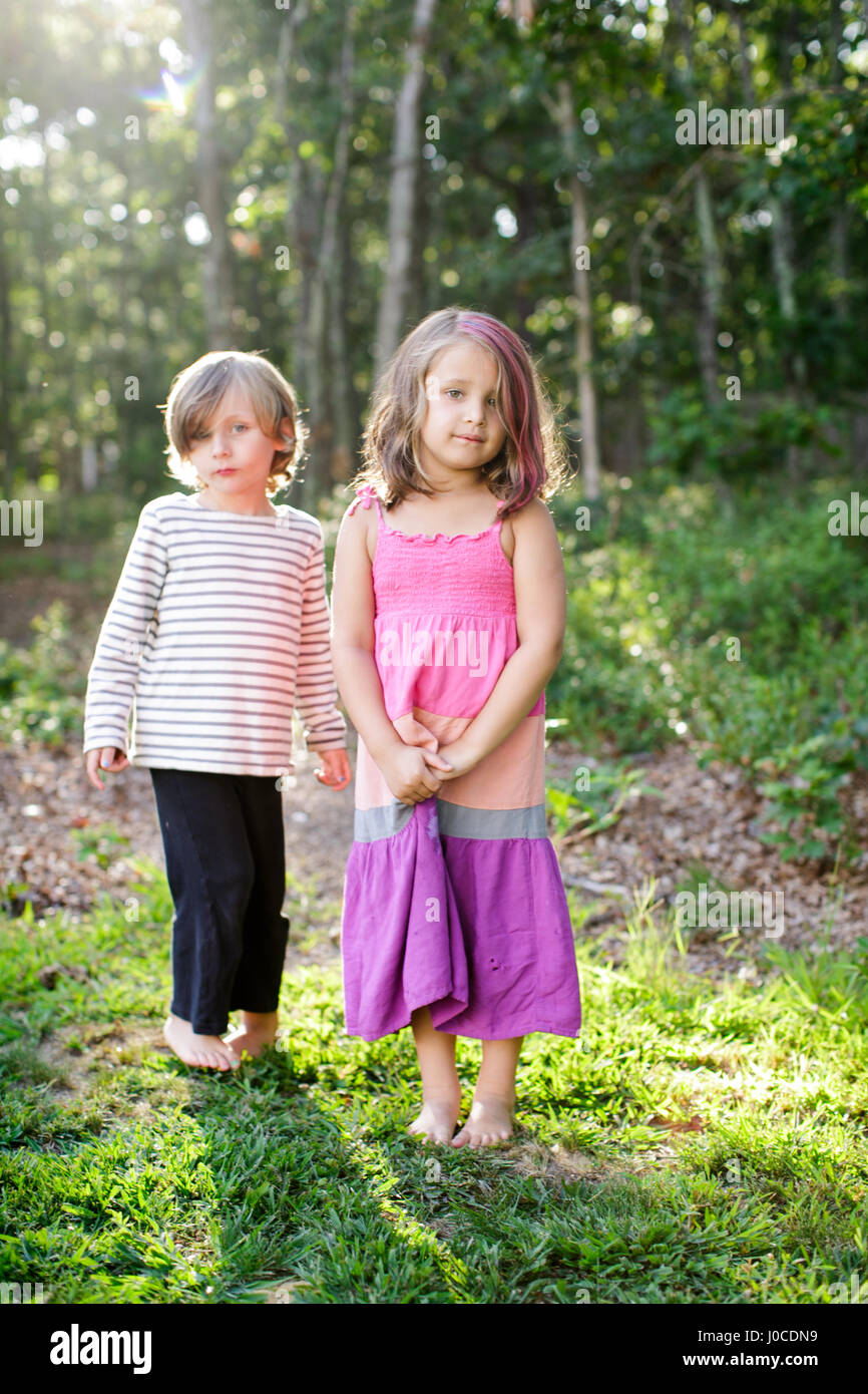 Portrait of boy and girl standing in garden Stock Photo - Alamy