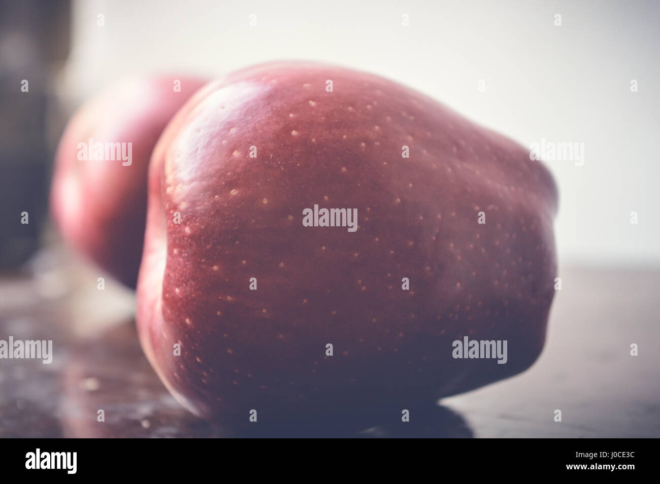closeup of red apple on wooden table Stock Photo