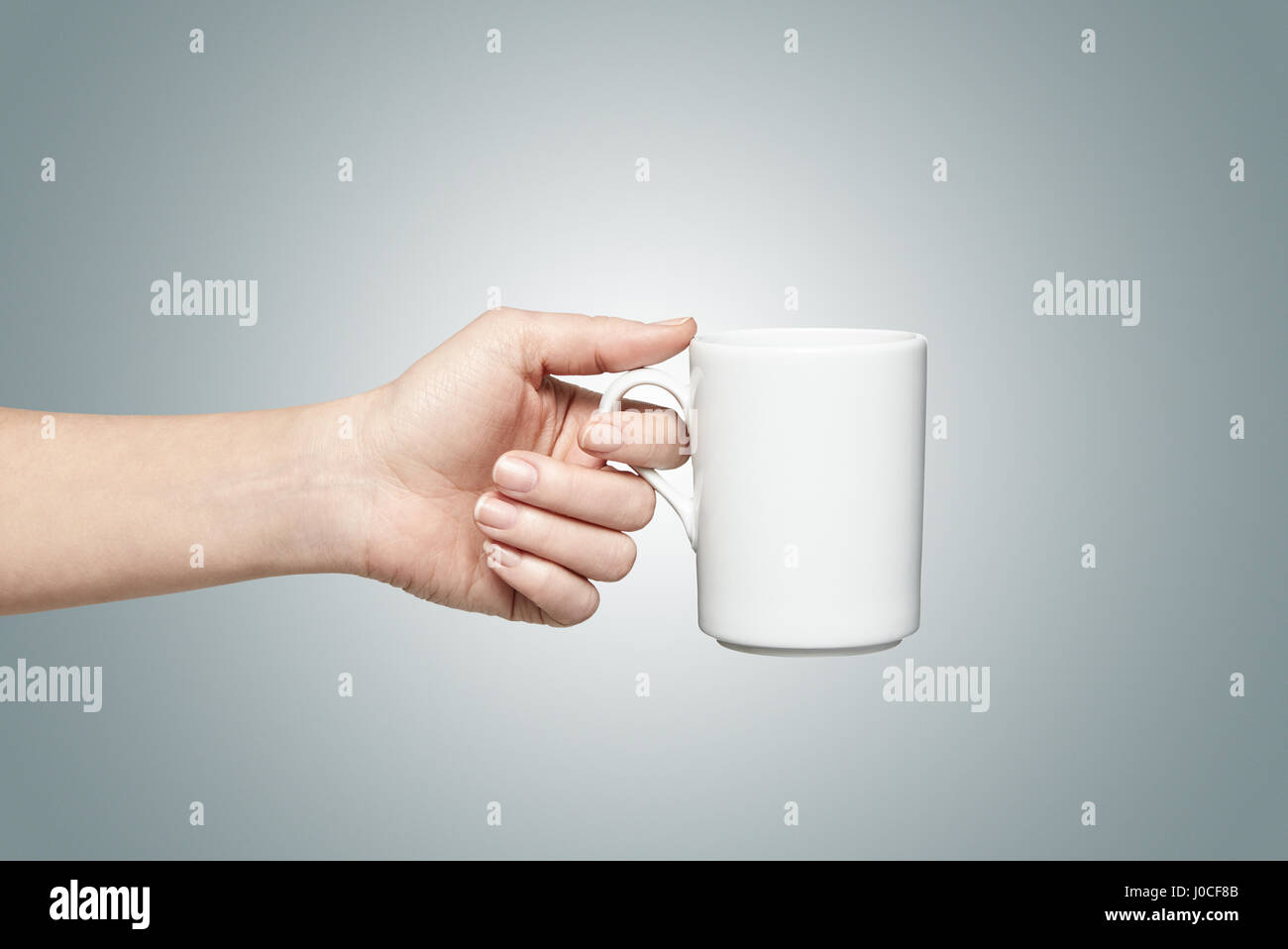 Woman holding a white mug Stock Photo