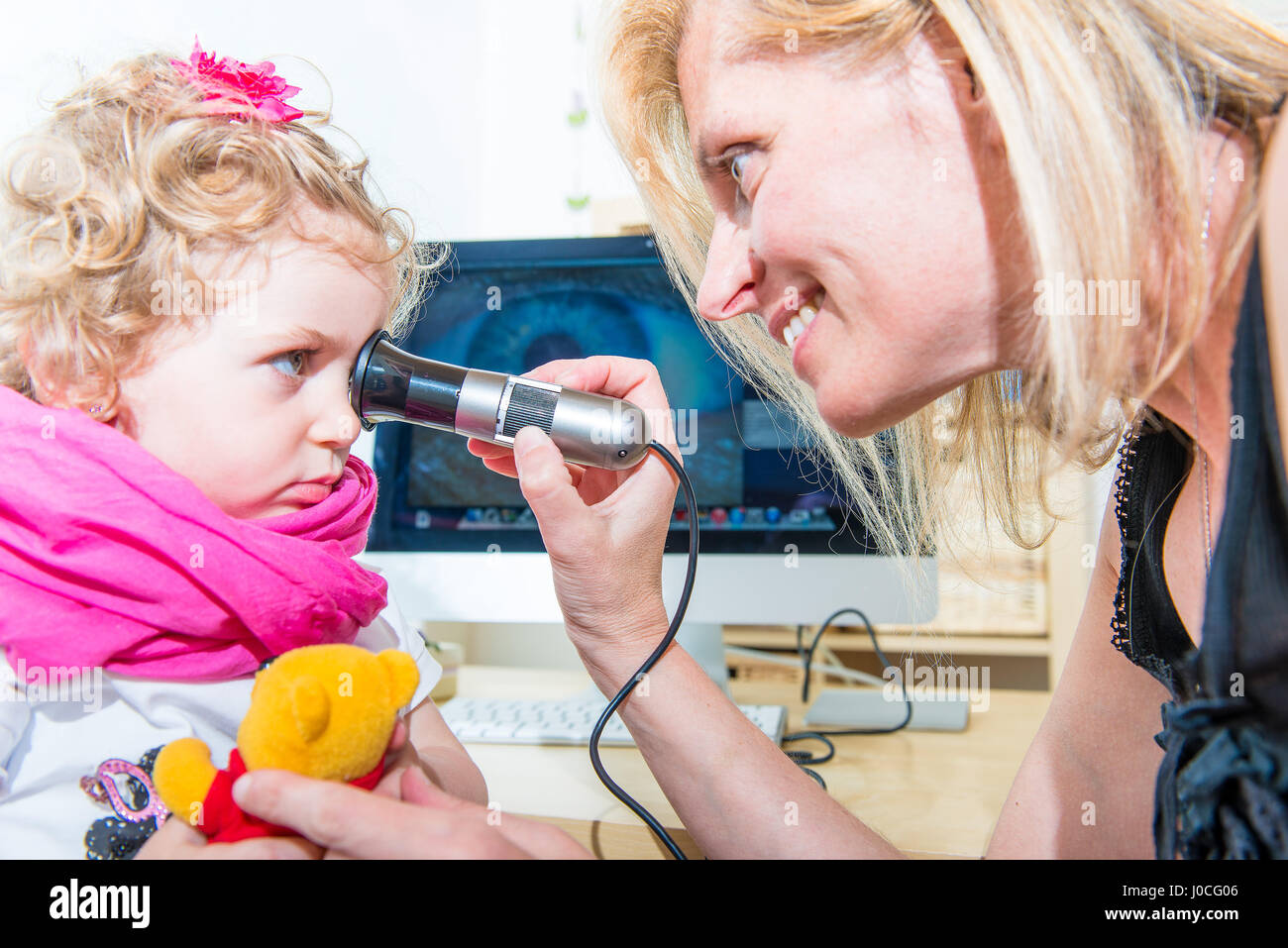 Visit iridology a female child in naturopath studio Stock Photo