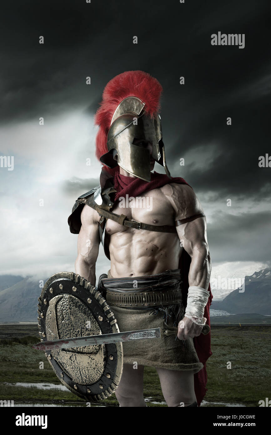 Ancient warrior or Gladiator posing outdoors with helmet Stock Photo ...