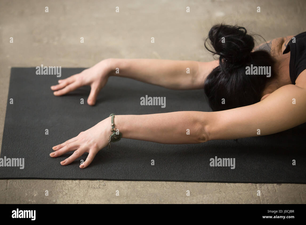 Close up of woman in Child pose on the mat Stock Photo