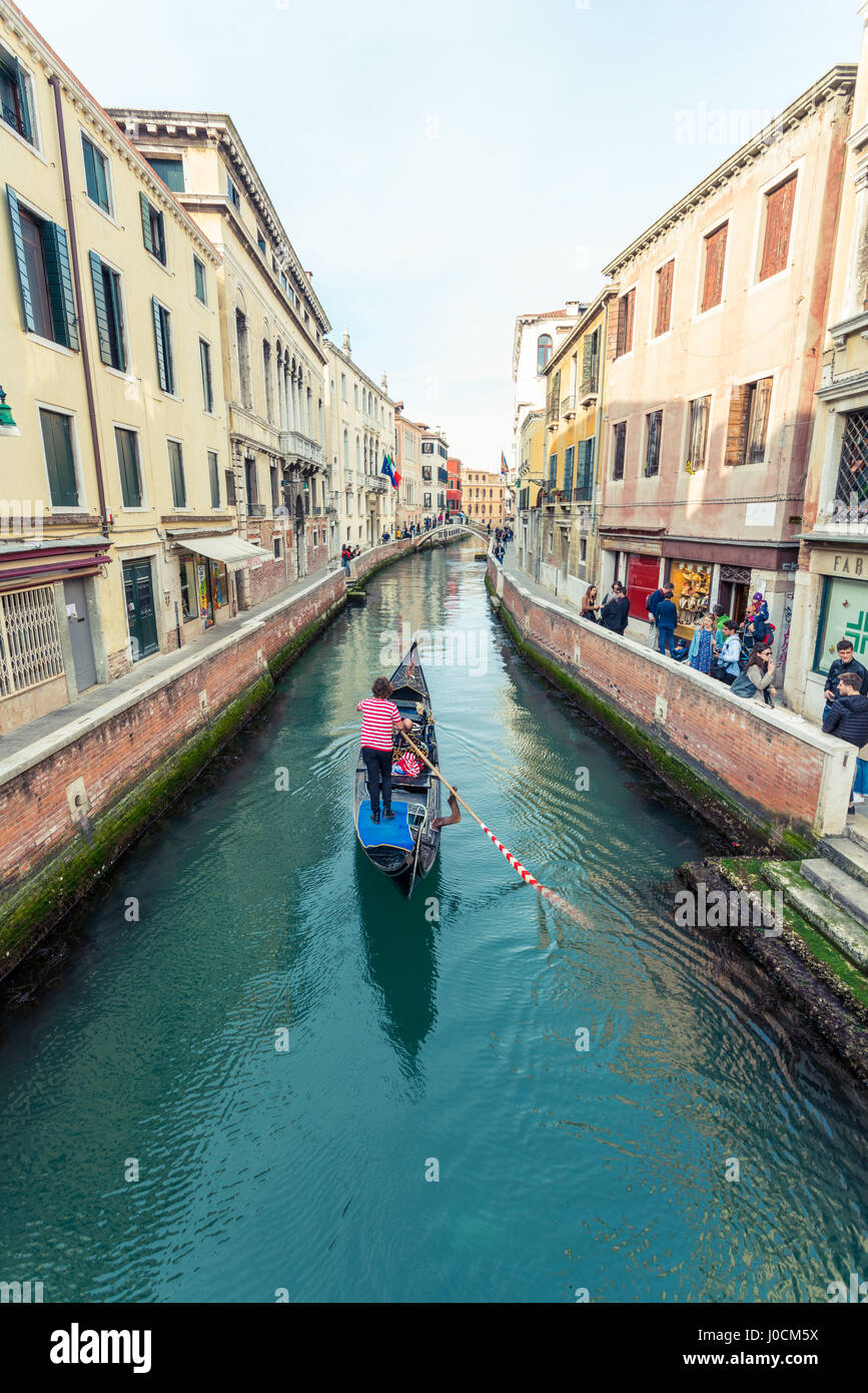 Gondola floating in a narrow canal in Venice, Italy Stock Photo