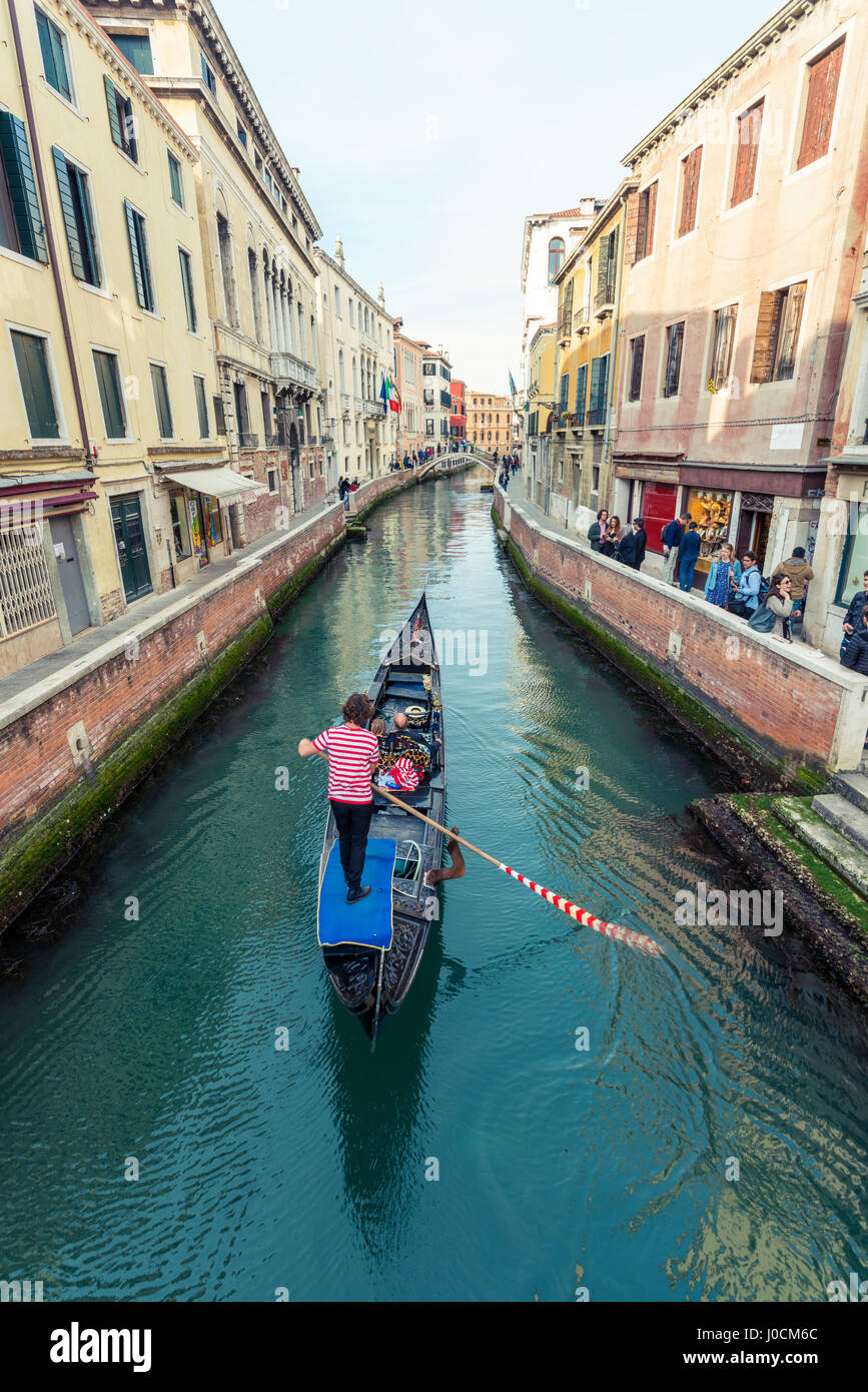 Gondola floating in a narrow canal in Venice, Italy Stock Photo