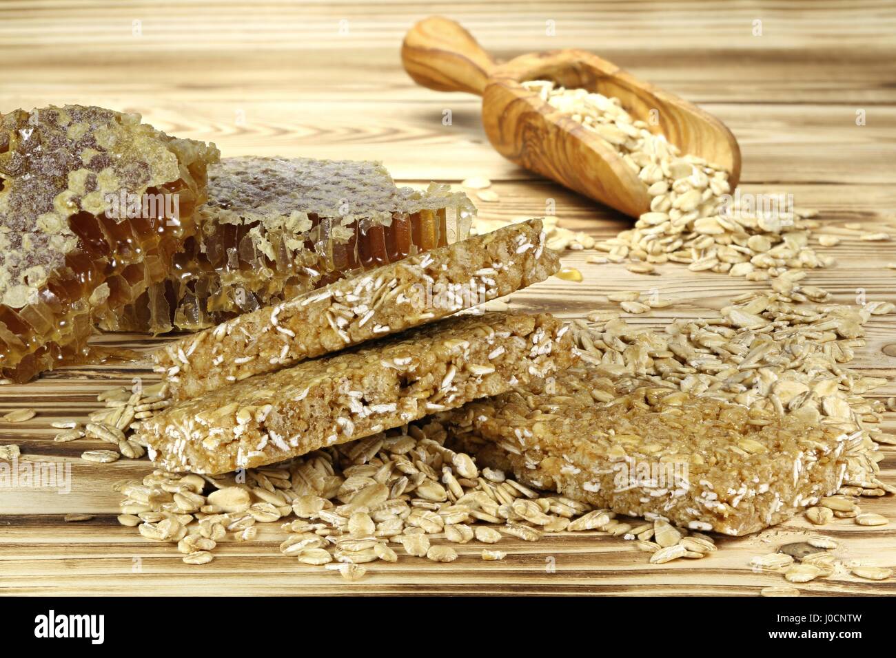 granola bars with ingredients on wooden background Stock Photo