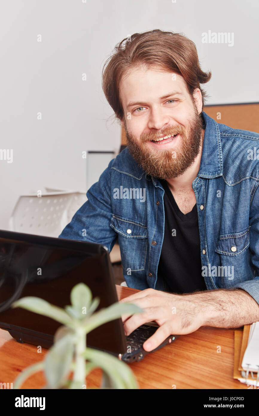 Man as programmer and computer scientist with laptop Stock Photo