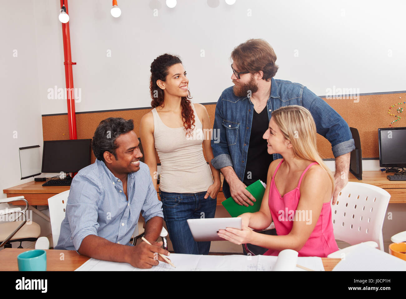Students as startup team in discussion at meeting Stock Photo