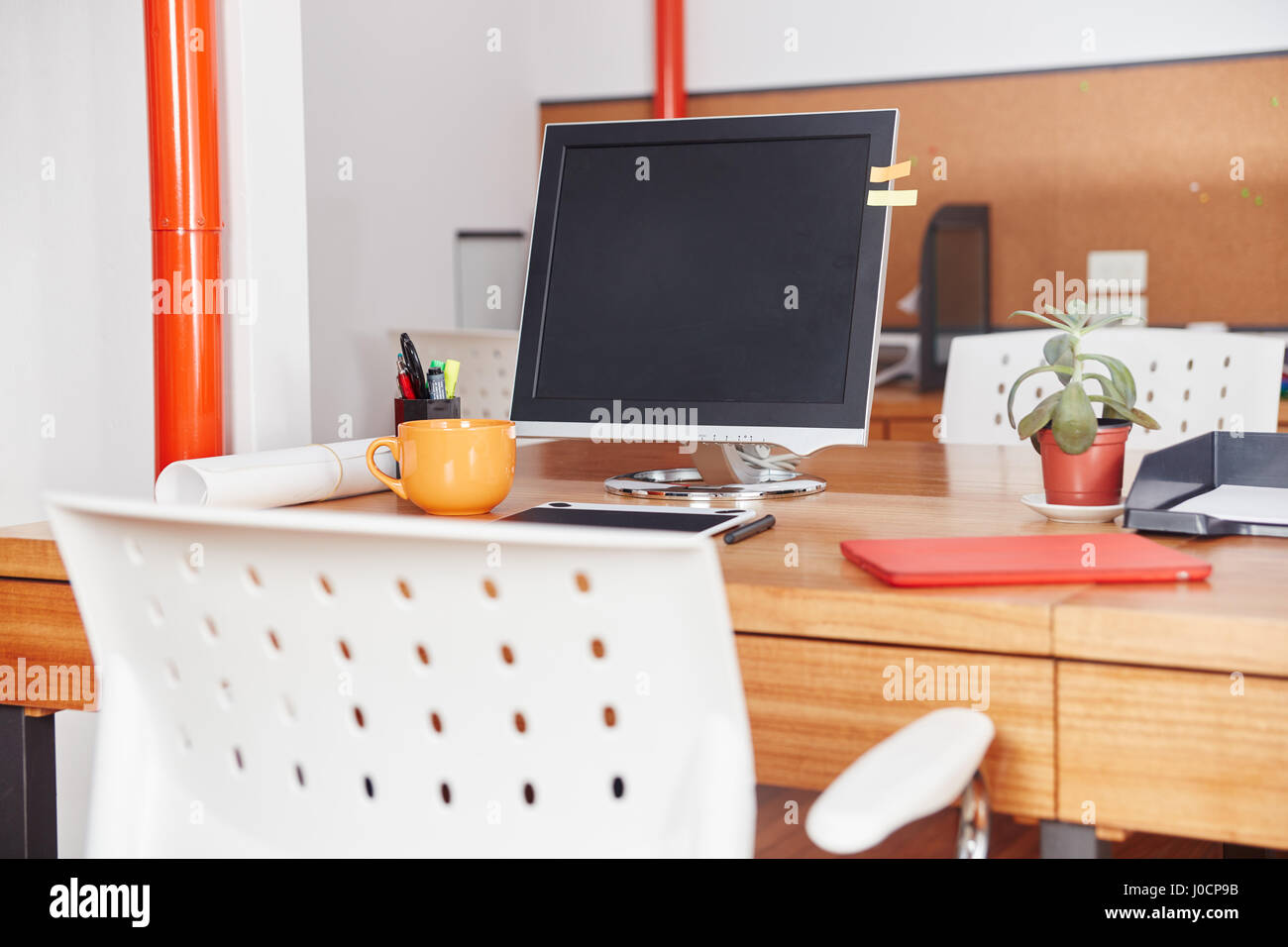 Place of work with desk and computer in business office Stock Photo