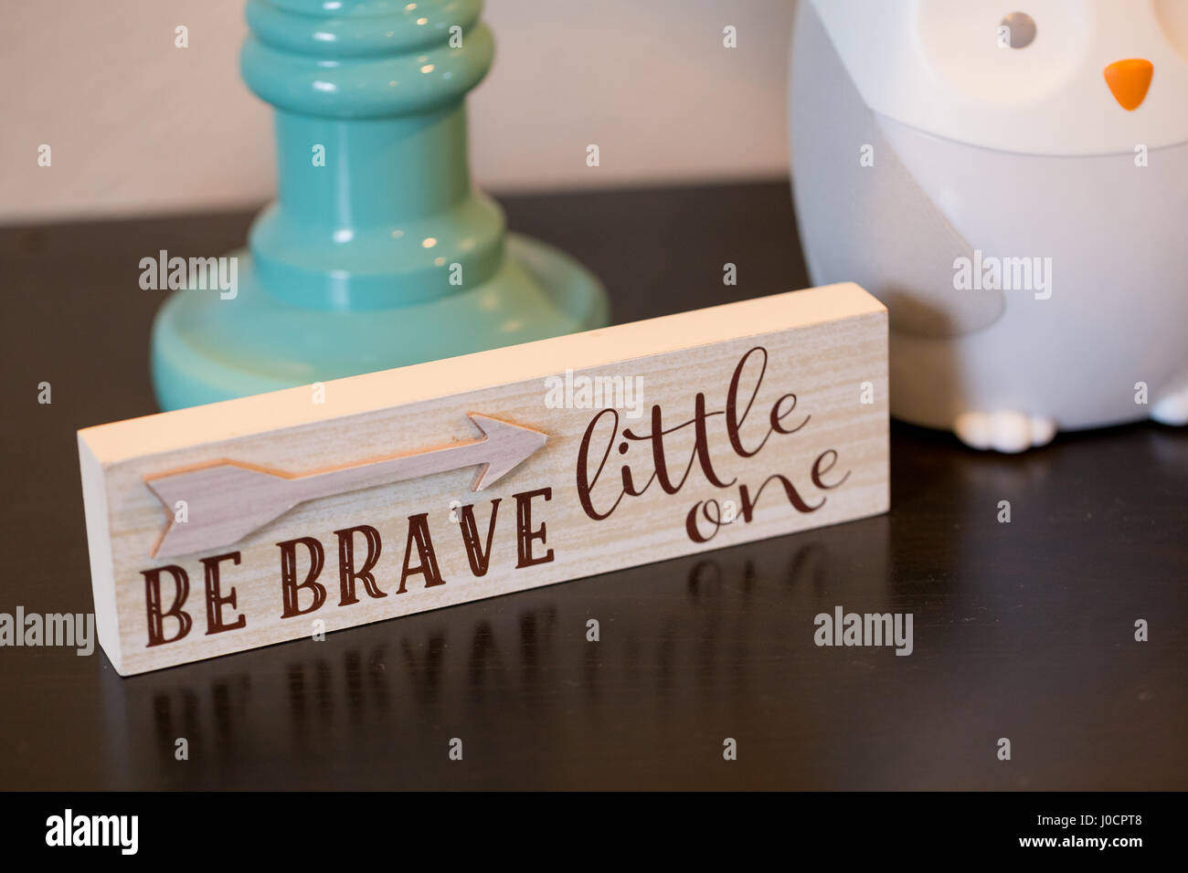 Be brave little one on a wood sign in the room of a young child. Stock Photo