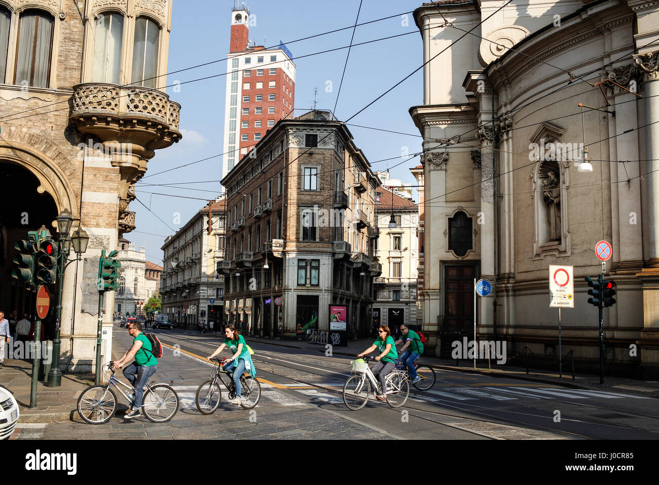 Turin downtown in a spring sunny day with people riding bicycles. Stock Photo