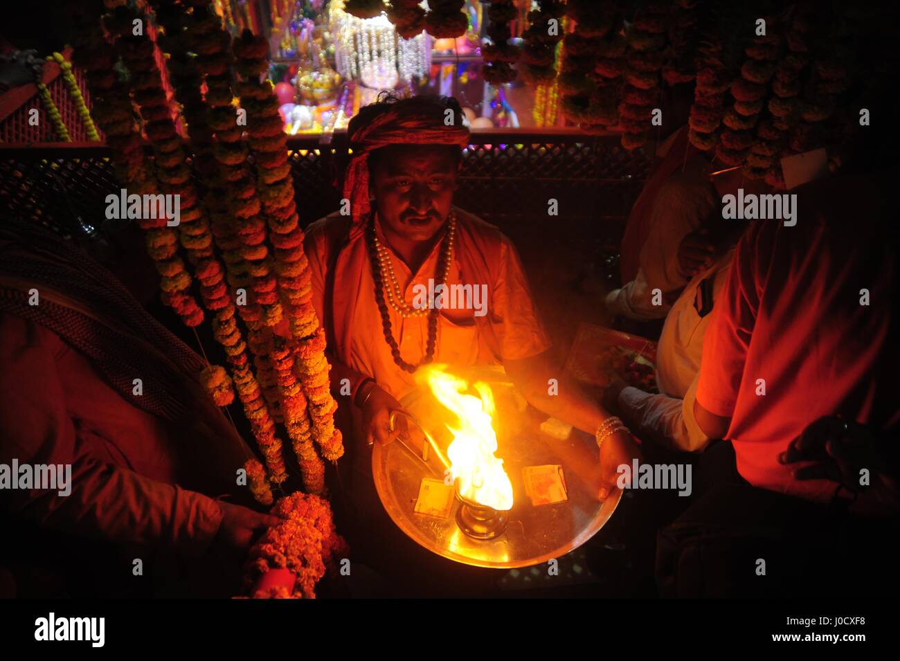 Allahabad, Uttar Pradesh, India. 11th Apr, 2017. Allahabad A priest carrying traditional oil