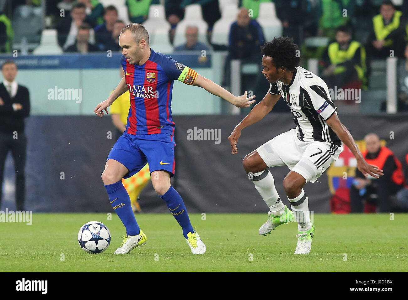 Turin, Italy. 11th Apr, 2017. Andres Iniesta (FCB Barcelona) and Juan Cuadrado (Juventus FC) compete for the ball during the 1st leg of Champions League quarter-final between Juventus FC and FCB Barcelona at Juventus Stadium on April 11, 2017 in Turin, Italy. Juventus won 3-0 over Barcelona. Credit: Massimiliano Ferraro/Alamy Live News Stock Photo