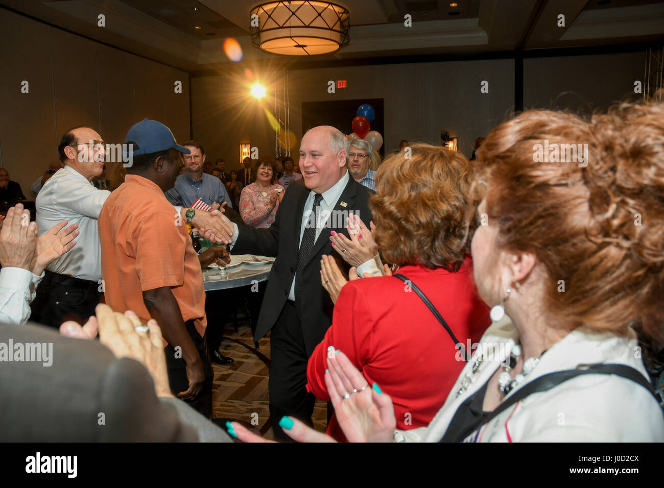 Wichita, U.S. 11th Apr, 2017. Republican Ron Estes the current Kansas State Treasurer wins the special election to fill the 4th congressional seat shakes hands with supporters at the victory party, Wichita Kansas, April 11, 2017. Credit: mark reinstein/Alamy Live News Stock Photo
