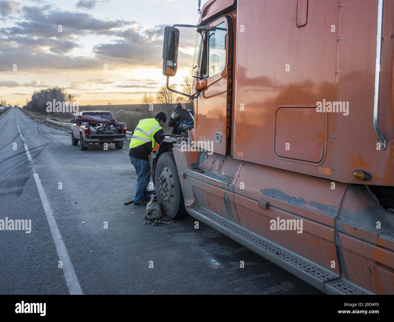 Mechanics repair in the field the truck damaged during the accident ...
