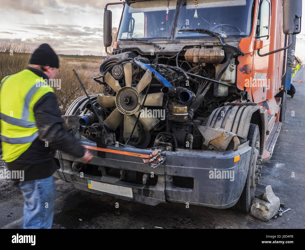 Mechanics repair in the field the truck damaged during the accident ...