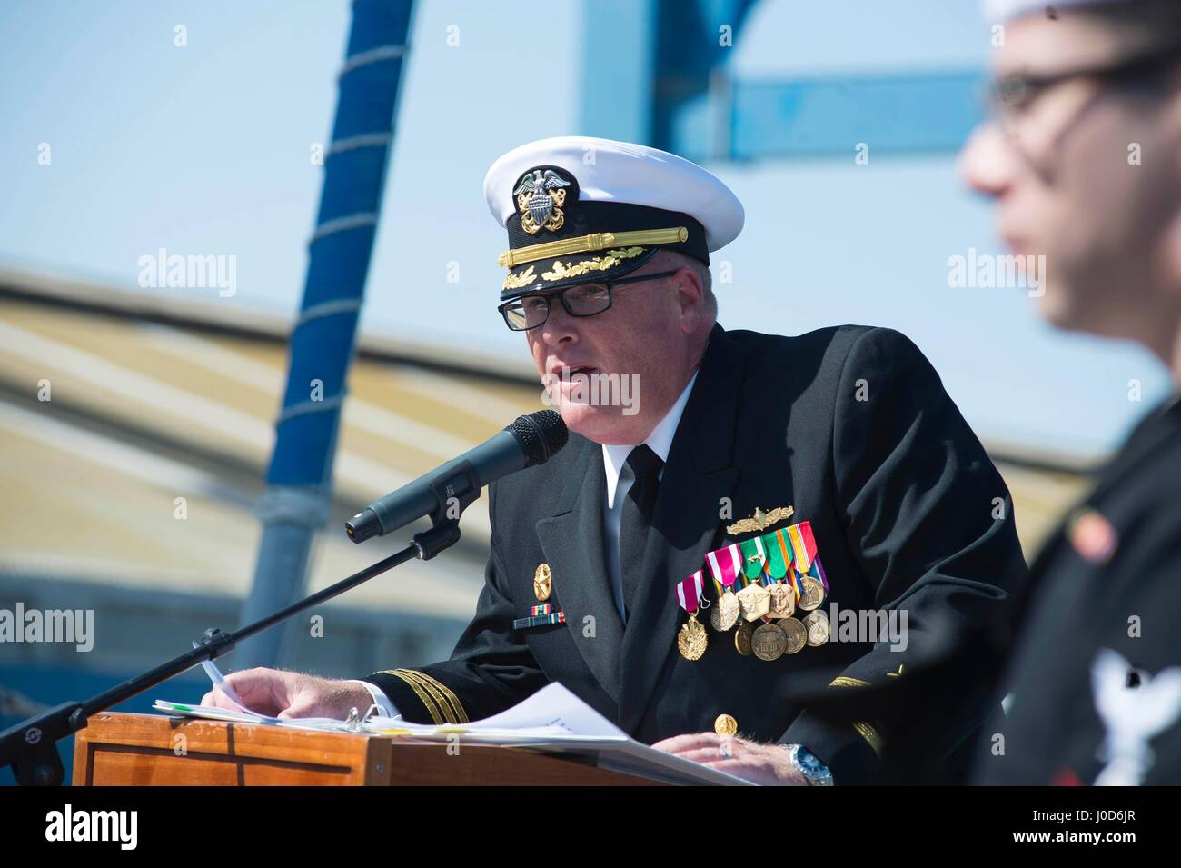 Larnaca, Cyprus. 11th Apr, 2017. U.S. Navy Cmdr. Russell Caldwell speaks during a routine change of command ceremony aboard USS Ross April 11, 2017 in Larnaca, Cyprus. Caldwell, led the ships missile assault on Syria on April 7th, turned over the helm to Cmdr. Bryan Gallo. Credit: Planetpix/Alamy Live News Stock Photo