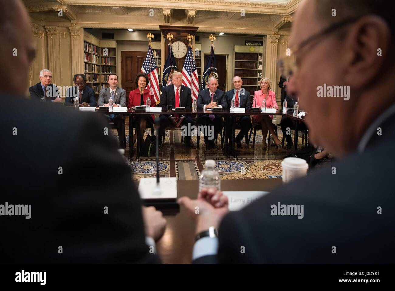 U.S President Donald Trump attends a strategic and policy discussion with business leaders in the State Department Library of the Eisenhower Executive Office Building April 11, 2017 in Washington, DC. Sitting alongside the president Left to Right are: Common Good founder Philip Howard, Bayo Ogunlesi of Global Infrastructure Partners, assistant to the president for intragovernmental and technology initiatives, Secretary of Transportation Elaine Chao, President Donald Trump, CEO of Blackstone Stephen Schwarzman, right, Chris Liddell, the assistant to the president for strategic initiatives, and  Stock Photo
