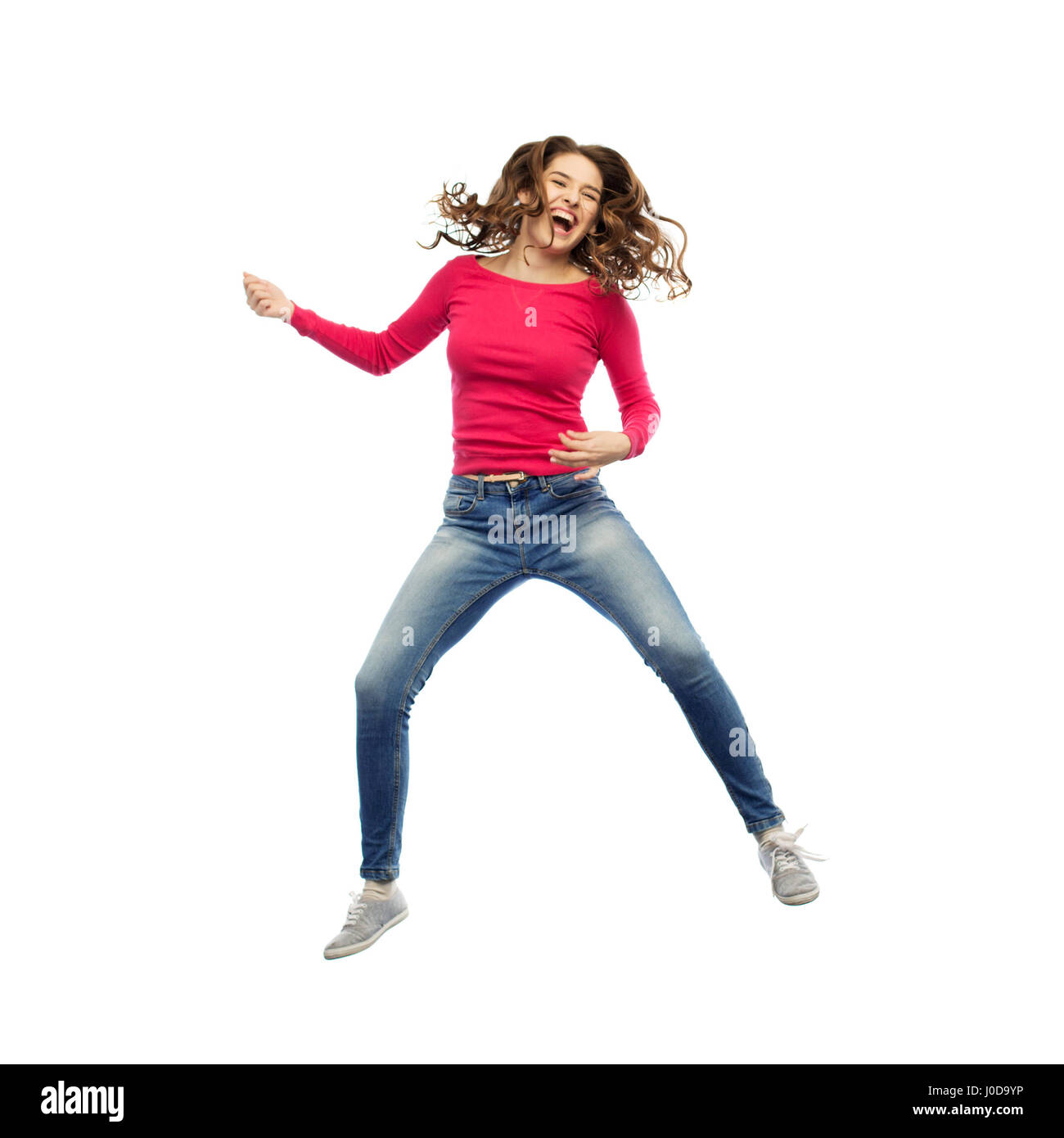 happy woman jumping and pretending guitar playing Stock Photo