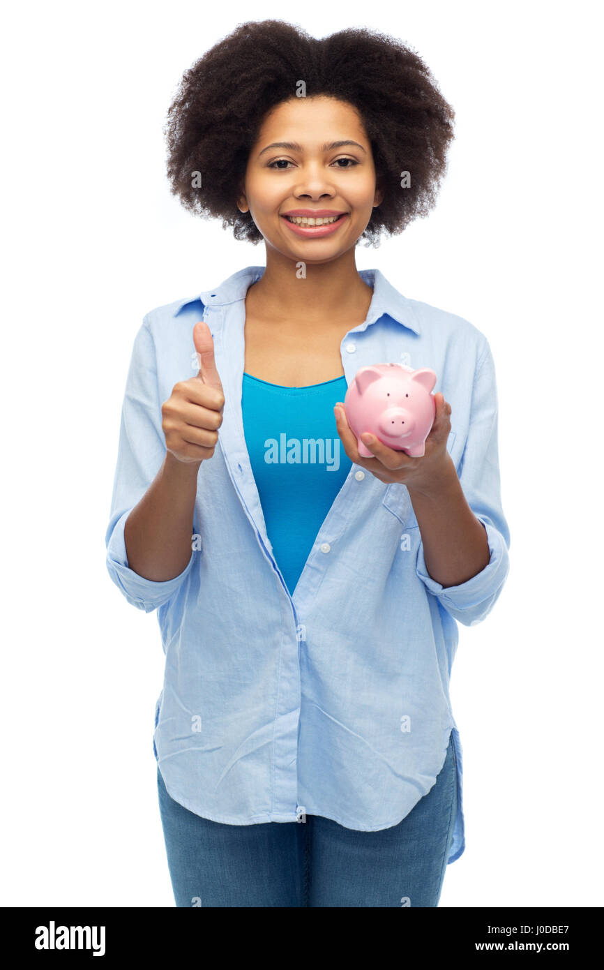 happy woman with piggy bank showing thumbs up Stock Photo - Alamy