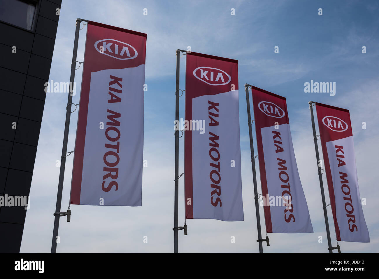 Kia Motors logo on flags Stock Photo