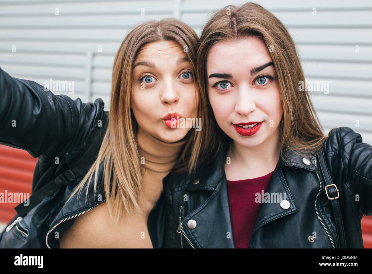 Two young girls taking selfie using smartphone Stock Photo