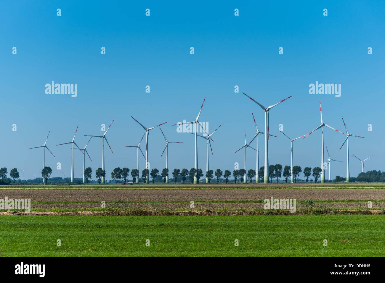 Wind Turbines in front of blue sky Stock Photo - Alamy