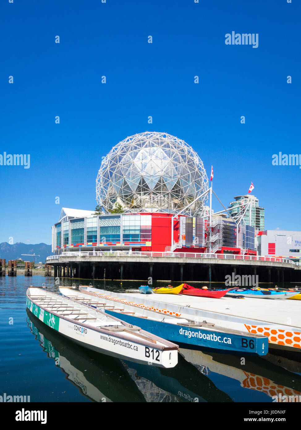 Science World at Telus World of Science (background) and the Dragon Zone Paddling Club (foreground) on False Creek in Vancouver, BC, Canada. Stock Photo