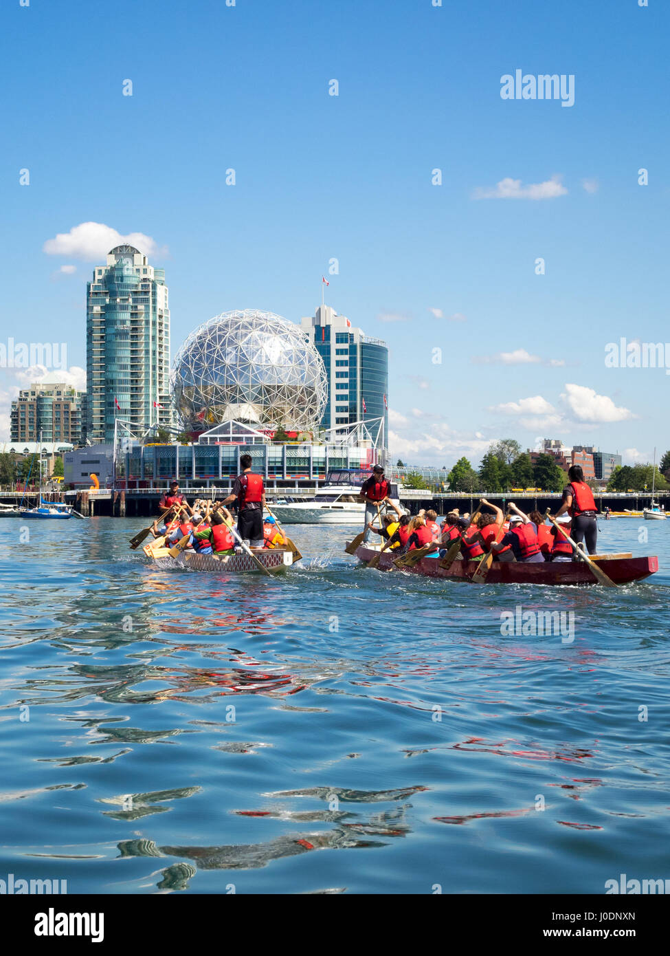 Dragon boat racing on False Creek in front of Science World at Telus World of Science in Vancouver, British Columbia, Canada. Stock Photo