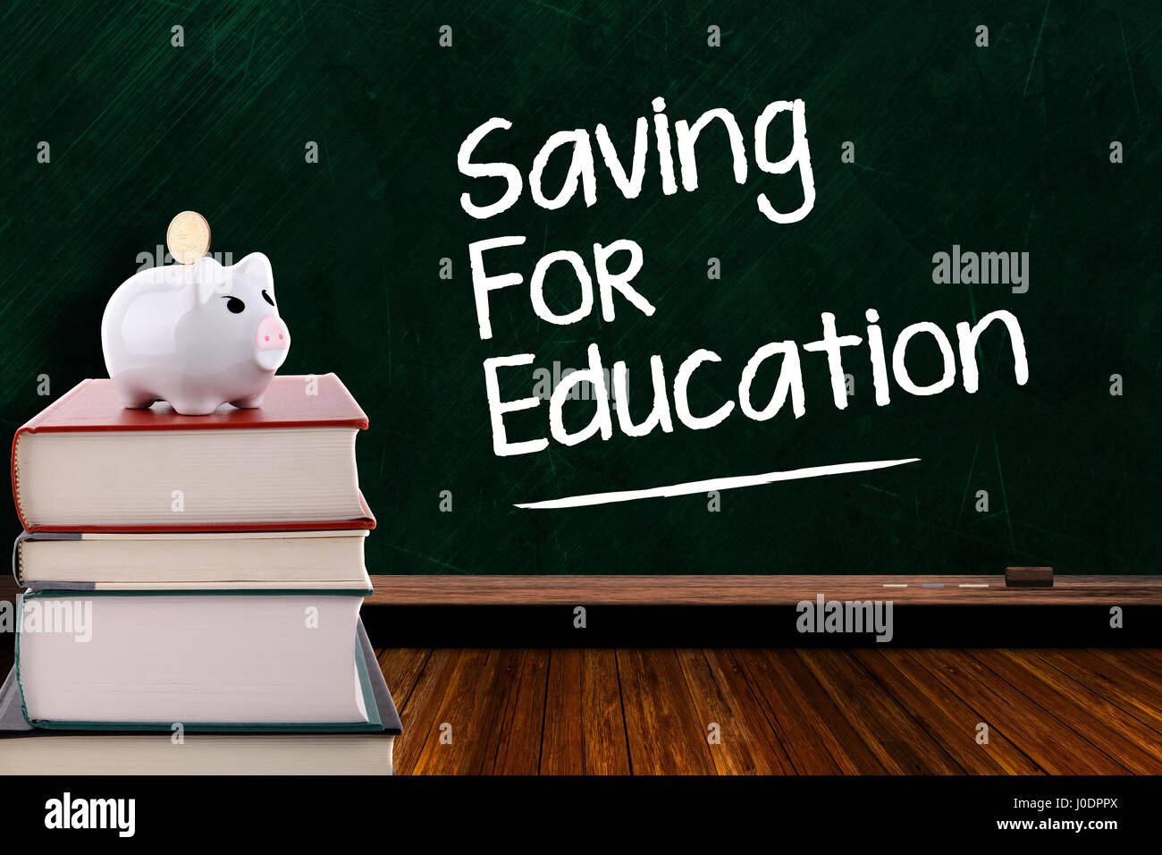 Piggy bank with coin on a stack of books on chalkboard background and copy space. Concept of saving for education and rising cost of education. Stock Photo