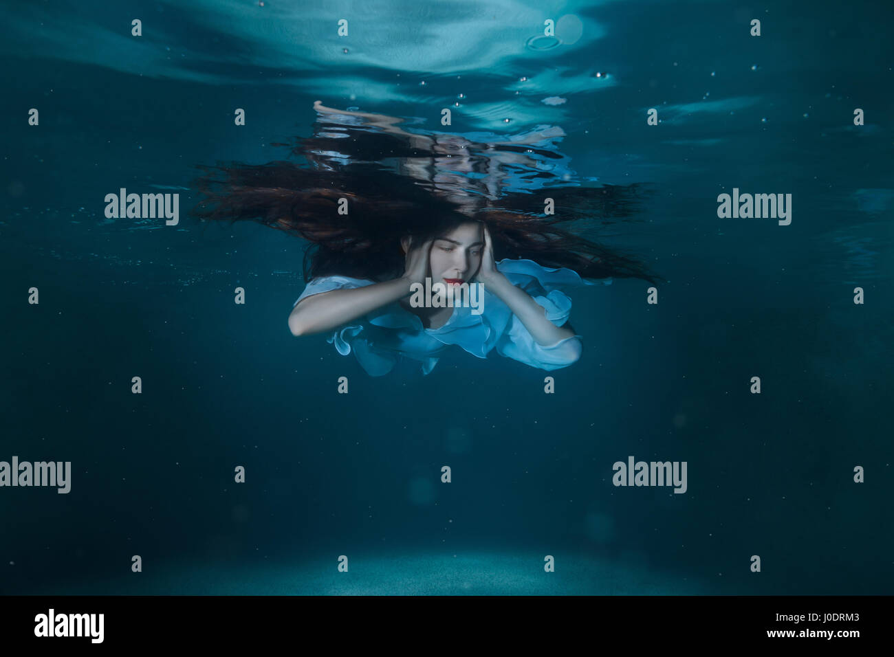 Woman floating underwater in pool hi-res stock photography and images ...