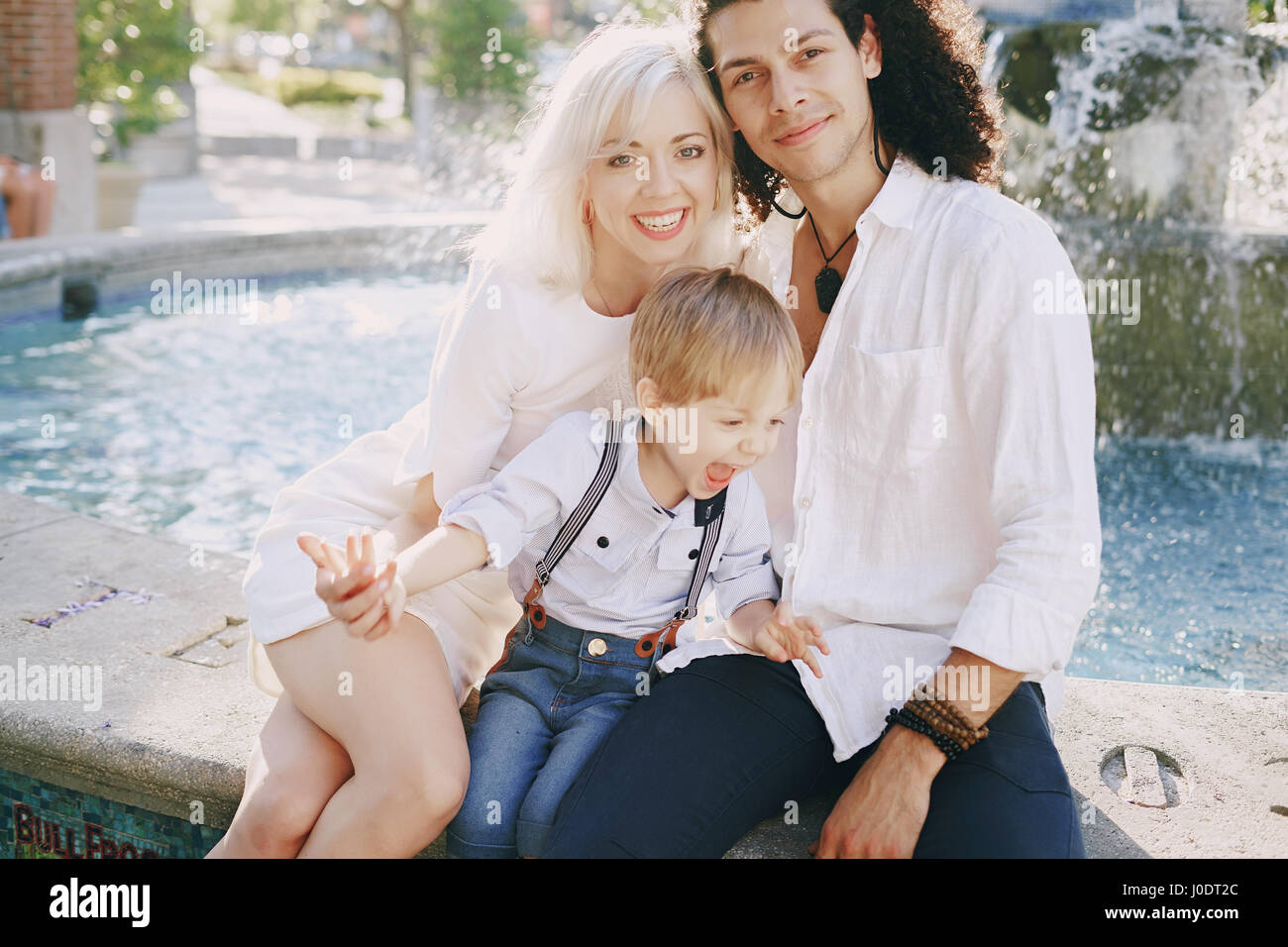 Dad Mom And A Little Boy With Blond Hair Walking Around The City