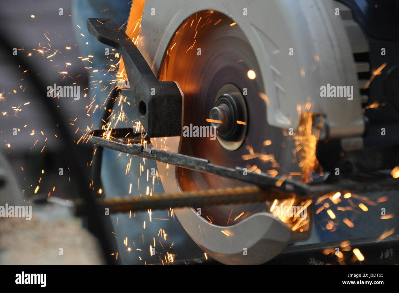 a circular power saw cuts through rebar with sparks Stock Photo Alamy