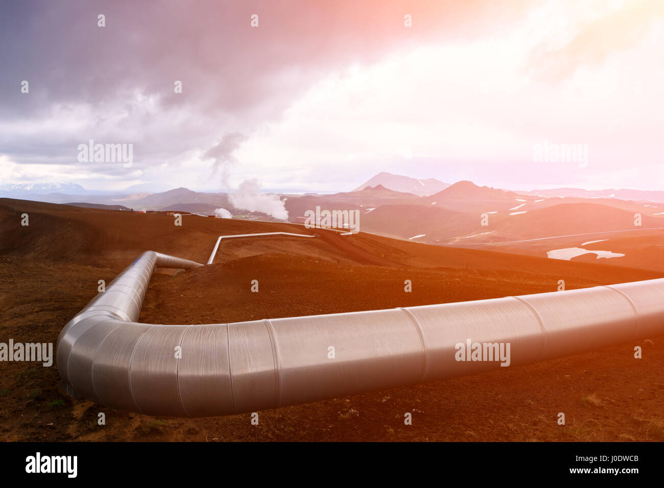 Iceland landscape with pipes in mountains. Geothermal energy in operations. Stock Photo