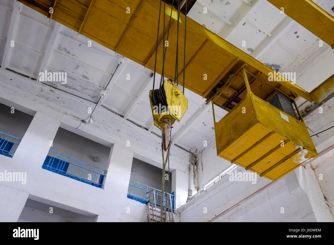 Hoist with winch and hook. A tool for moving goods in a production room ...
